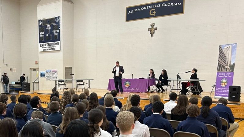 Judge Clary speaking with students in the Gesu Catholic School gymnasium